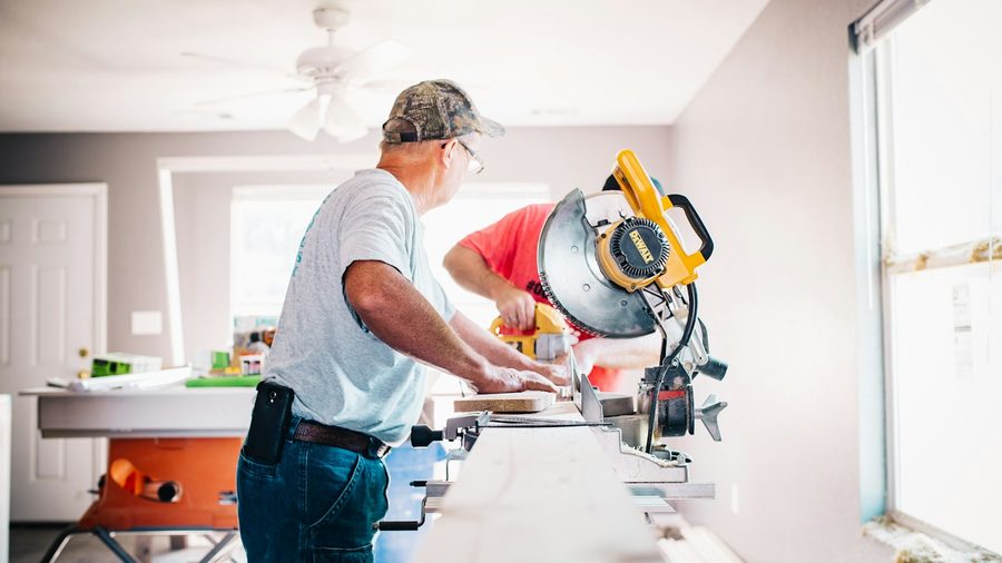 Contractor cutting timber during a fix-and-flip renovation