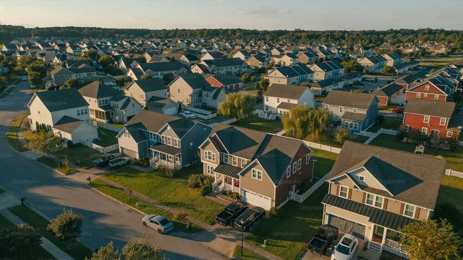 Aerial view of a suburban neighbourhood of investment properties at golden hour