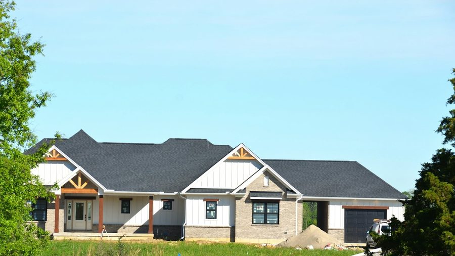 Modern investment home exterior with a dark pitched roof